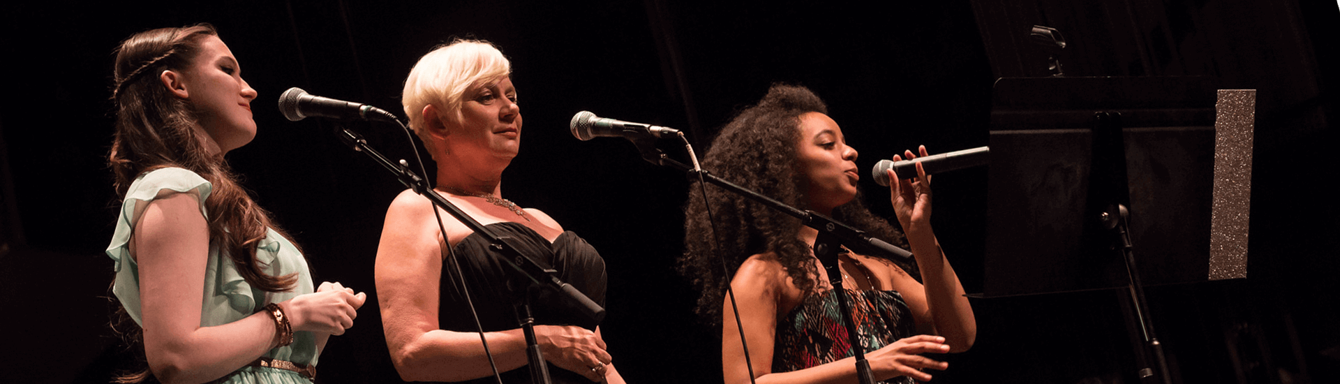 Three Women Singing on stage